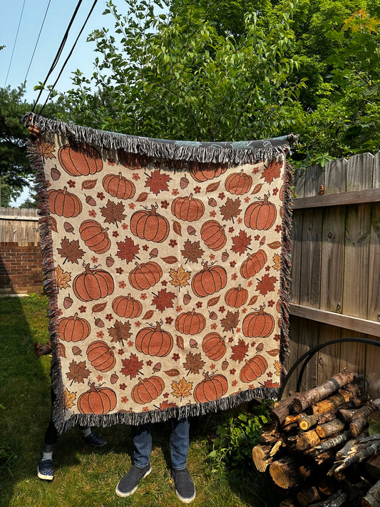 Fall Woven Blankets with pumpkin and autumn leaves.