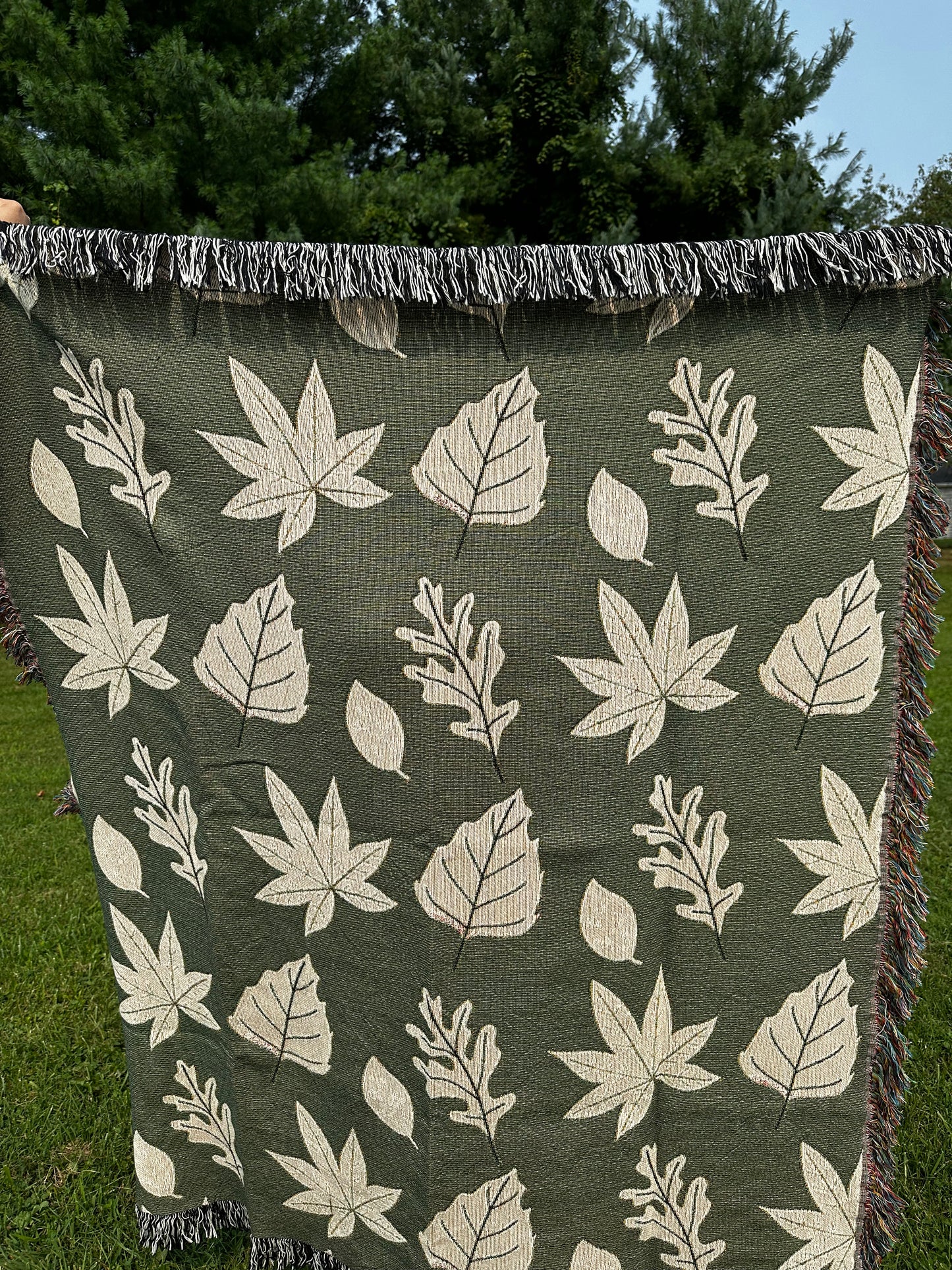 Fall leaves Woven Blanket with green background for autumn season.