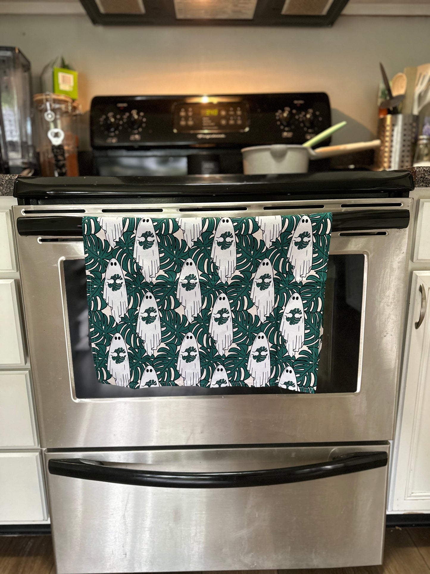 Cute ghost holding monstera leaf tea towel. Set of 2 cotton kitchen towels.